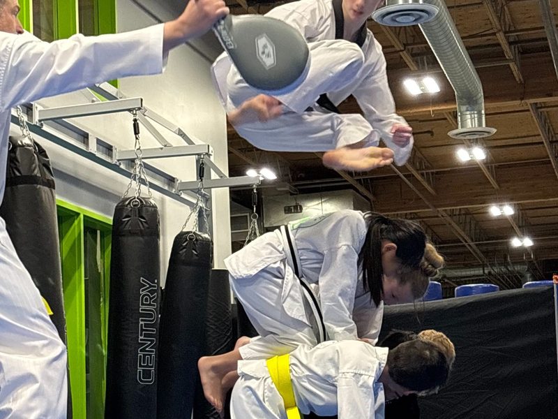 Students working through kicking drills on the heavy bags at the academy.